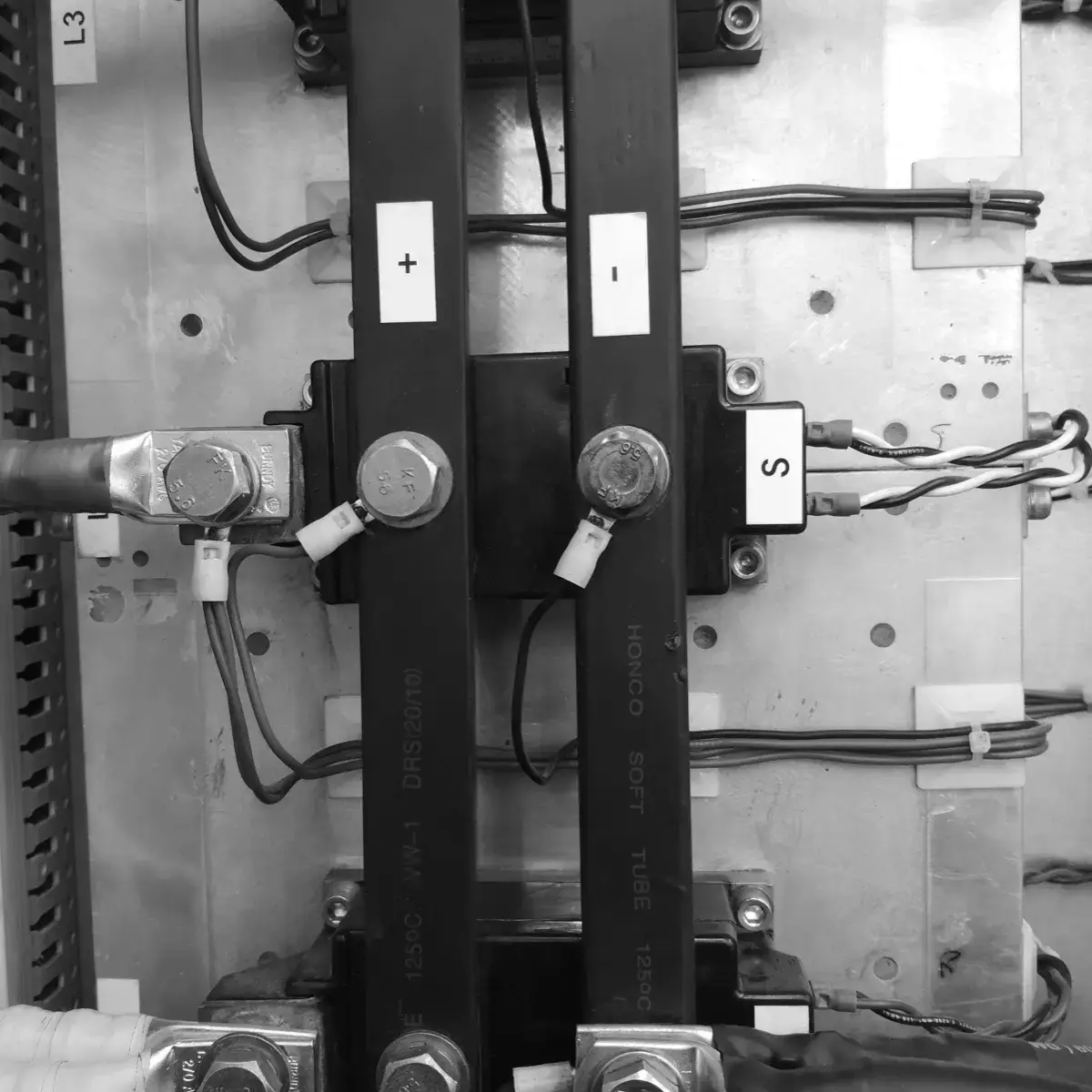 Direct current output busbars, marked + and −, bolted to the power modules and wired to the process with cable sized for the load.