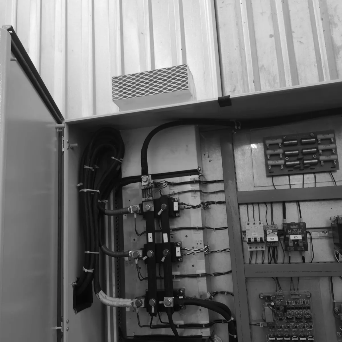Inside a cabinet, with the power wiring dressed and run in trunking