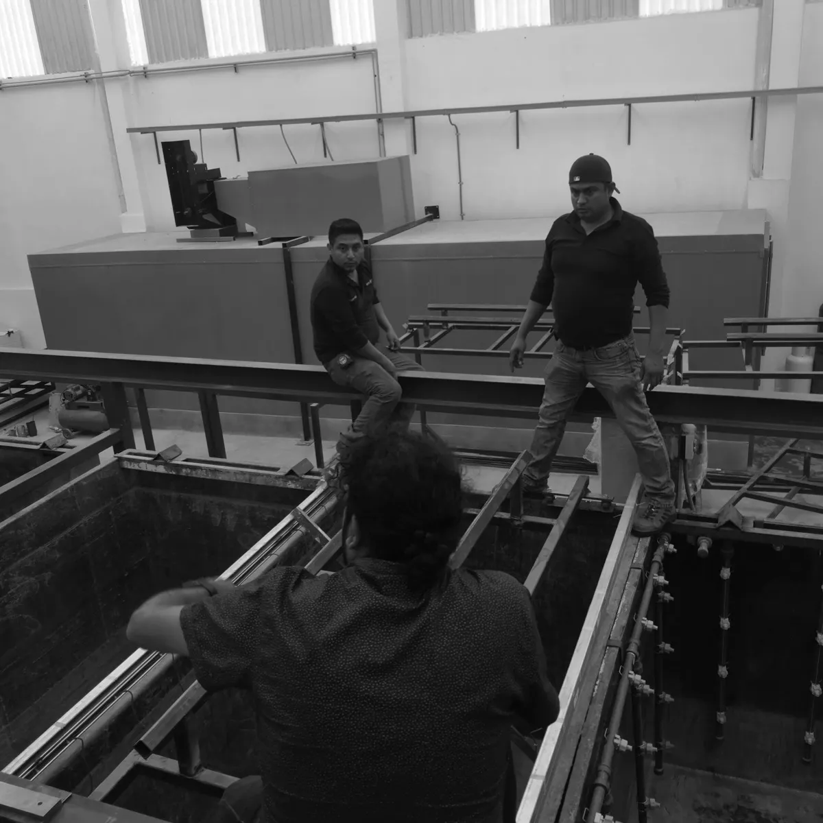 Installation work above the process tanks of a paint line