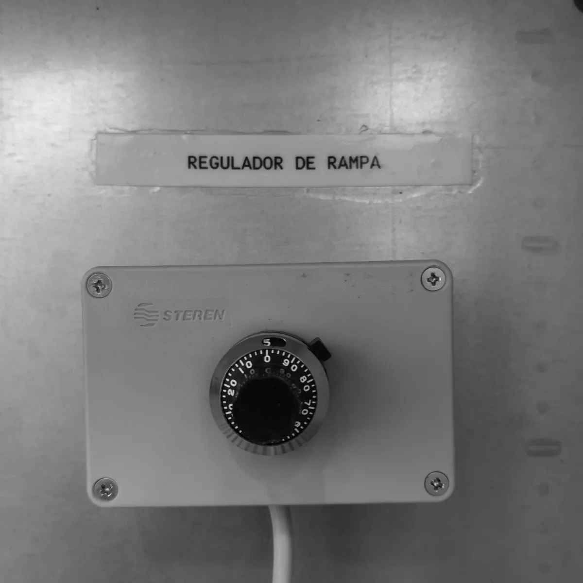 Voltage ramp regulator, labelled, on the door of a cabinet