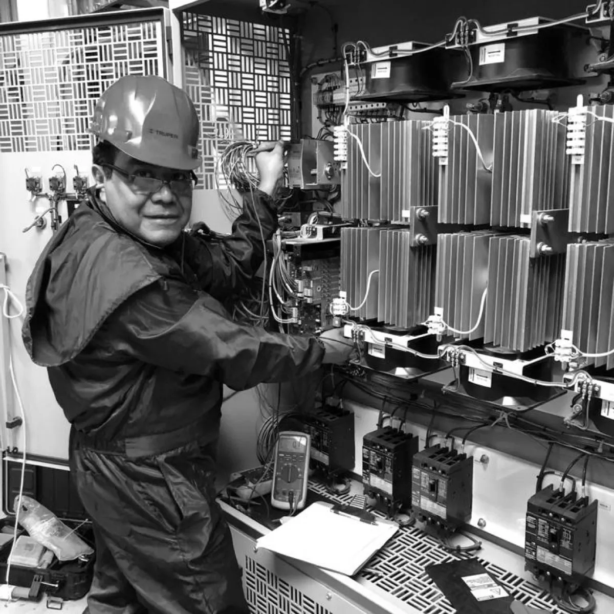 Adjusting the heatsinked power modules of a rectifier, multimeter in hand